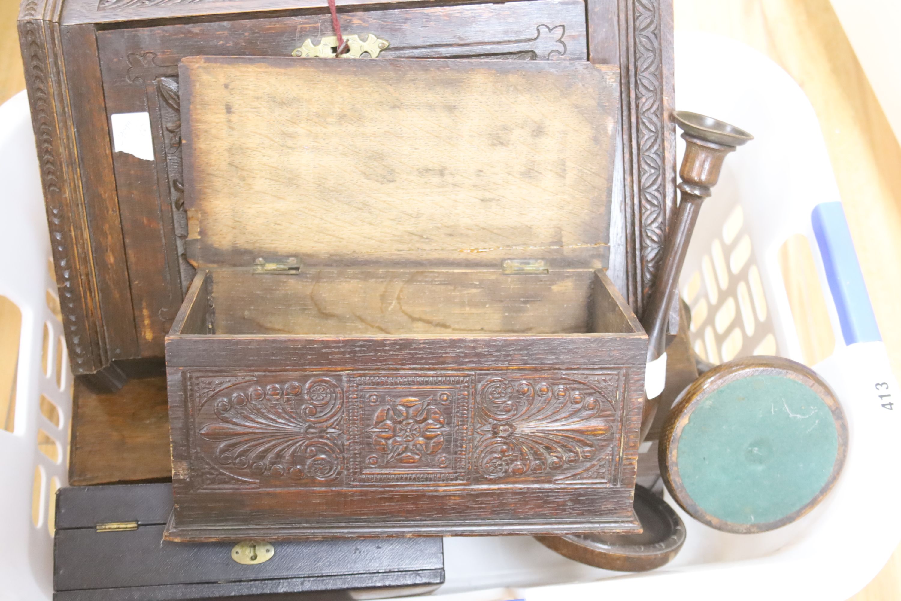 An 18th/19th century oak miniature trunk and miniature corner cupboard, one other miniature oak coffer, pair of candlesticks and leathe